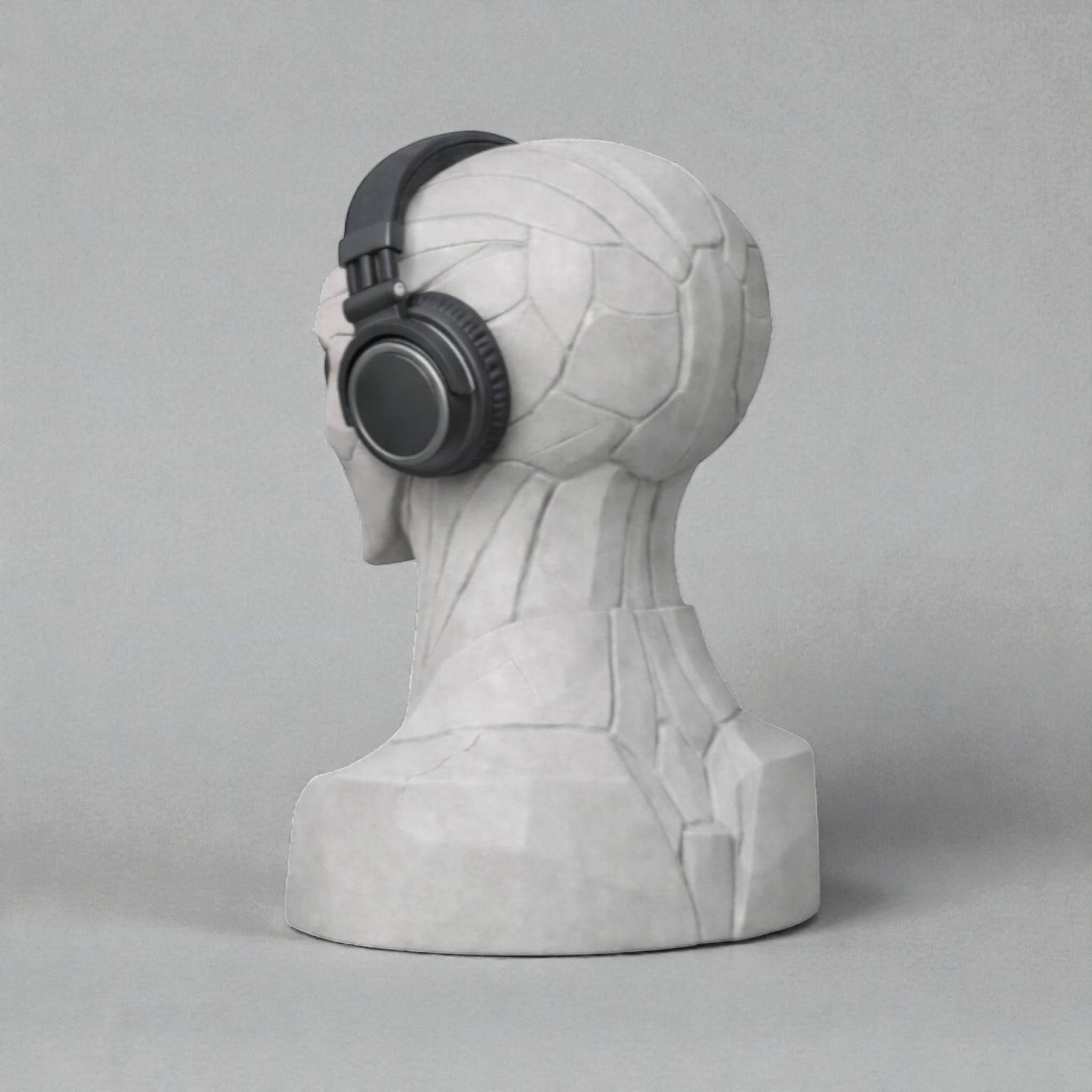 Happy3dWorld alien bust headphone stand in matte grey, displaying a black headset on a neutral background.