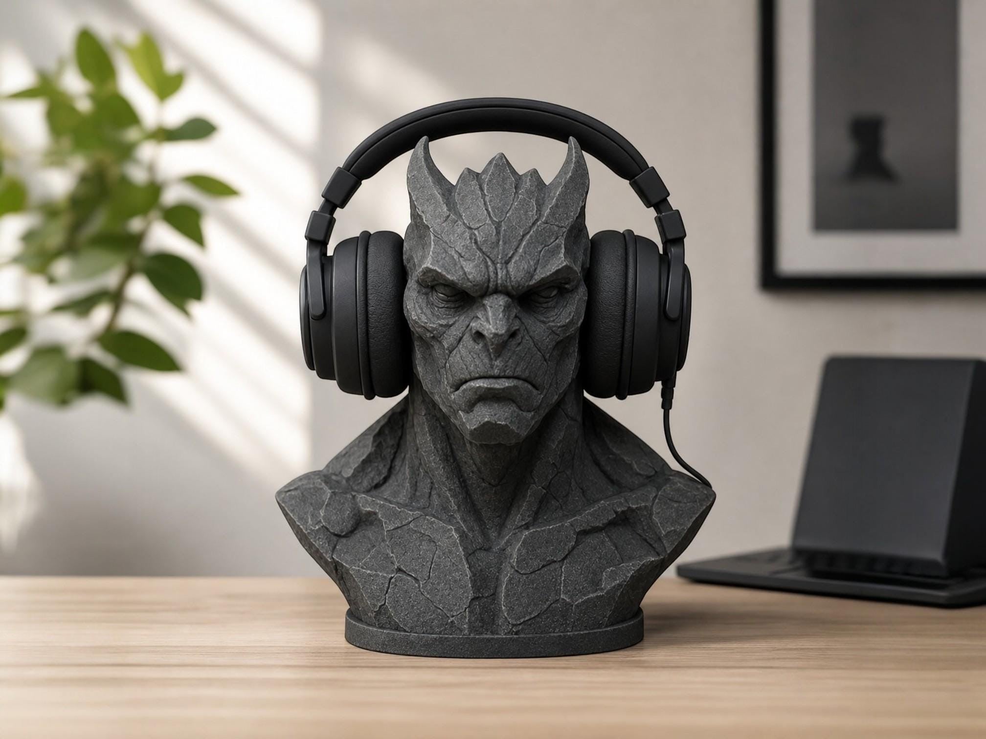 Happy3dWorld gray stone-textured 3D printed gargoyle headphone stand holding black gaming headset on a desk