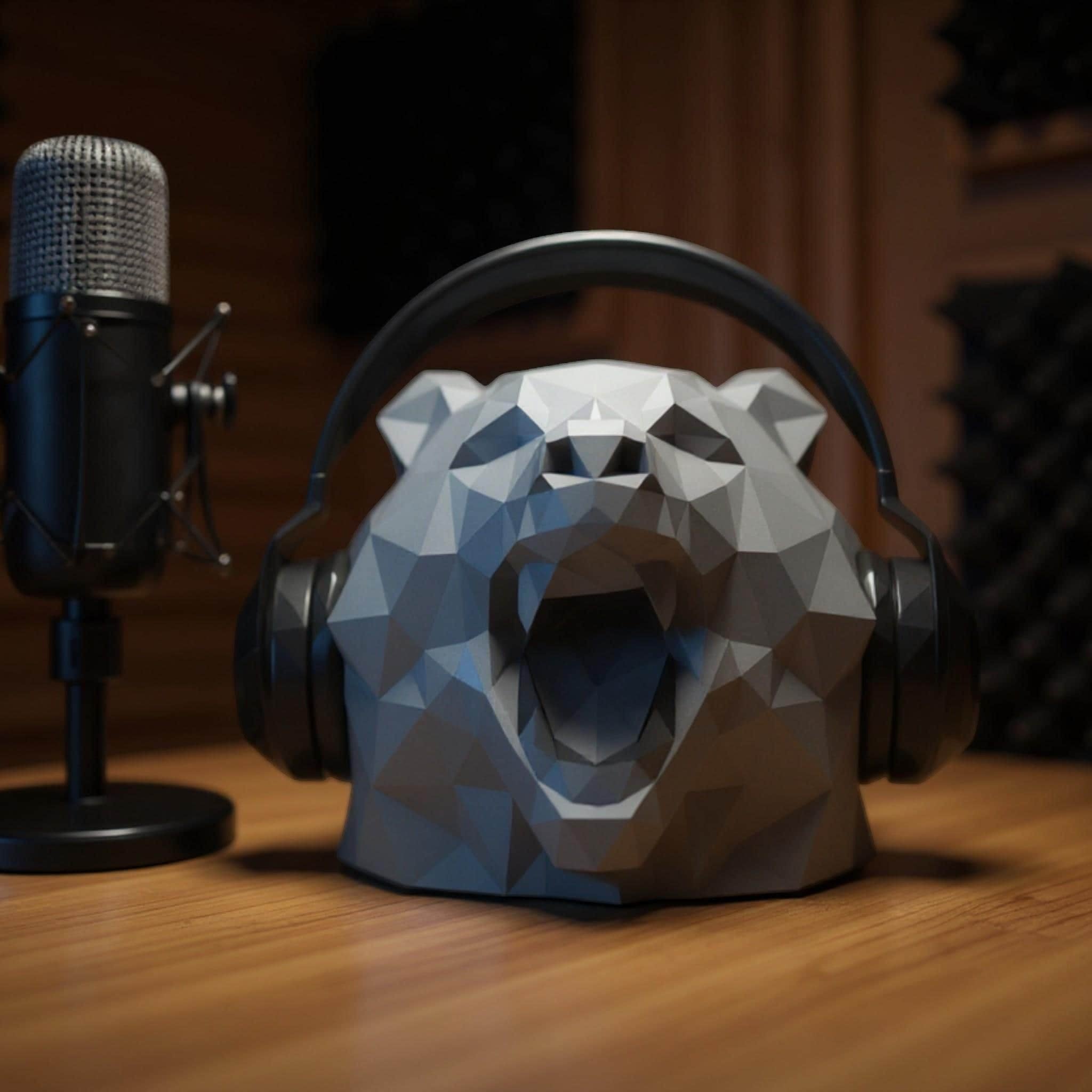 Happy3dWorld grey low-polygon bear head headphone stand on a wooden desk next to a professional microphone.