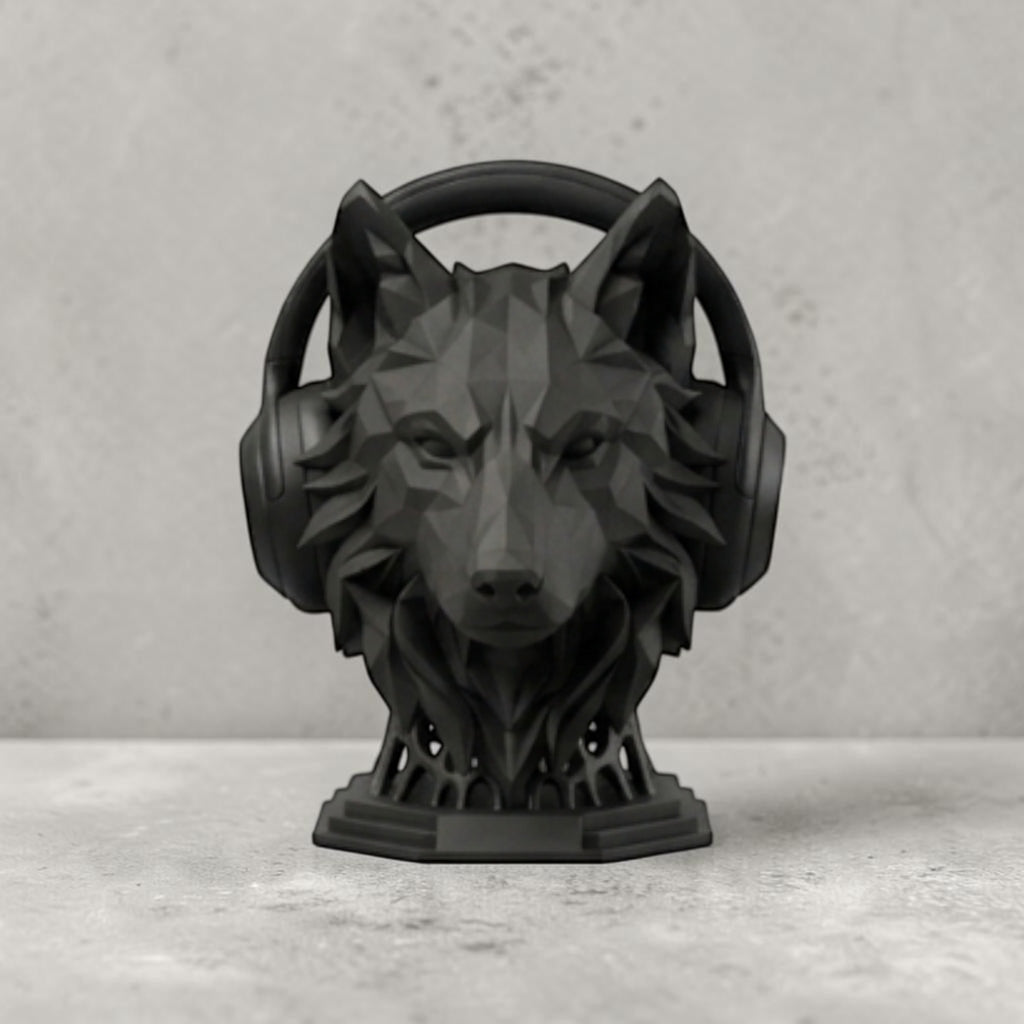 Happy3dWorld matte black geometric wolf headphone stand with a low-poly design on a grey desk surface.