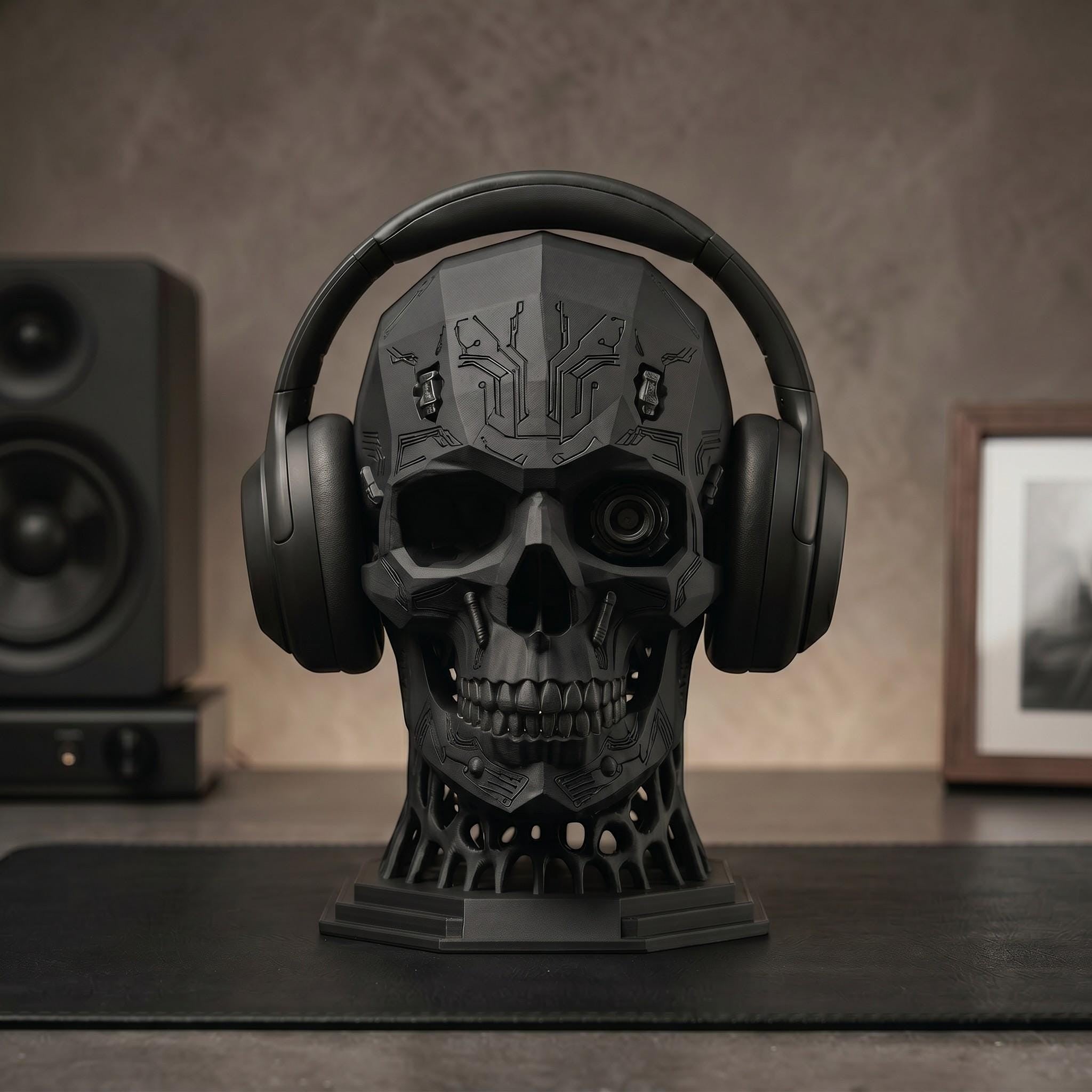 Happy3dWorld matte black mechanical skull headphone stand with cybernetic details on a desk with audio equipment.