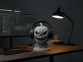Happy3dWorld 3D printed matte grey pumpkin skull headphone stand on a desk with over-ear headphones