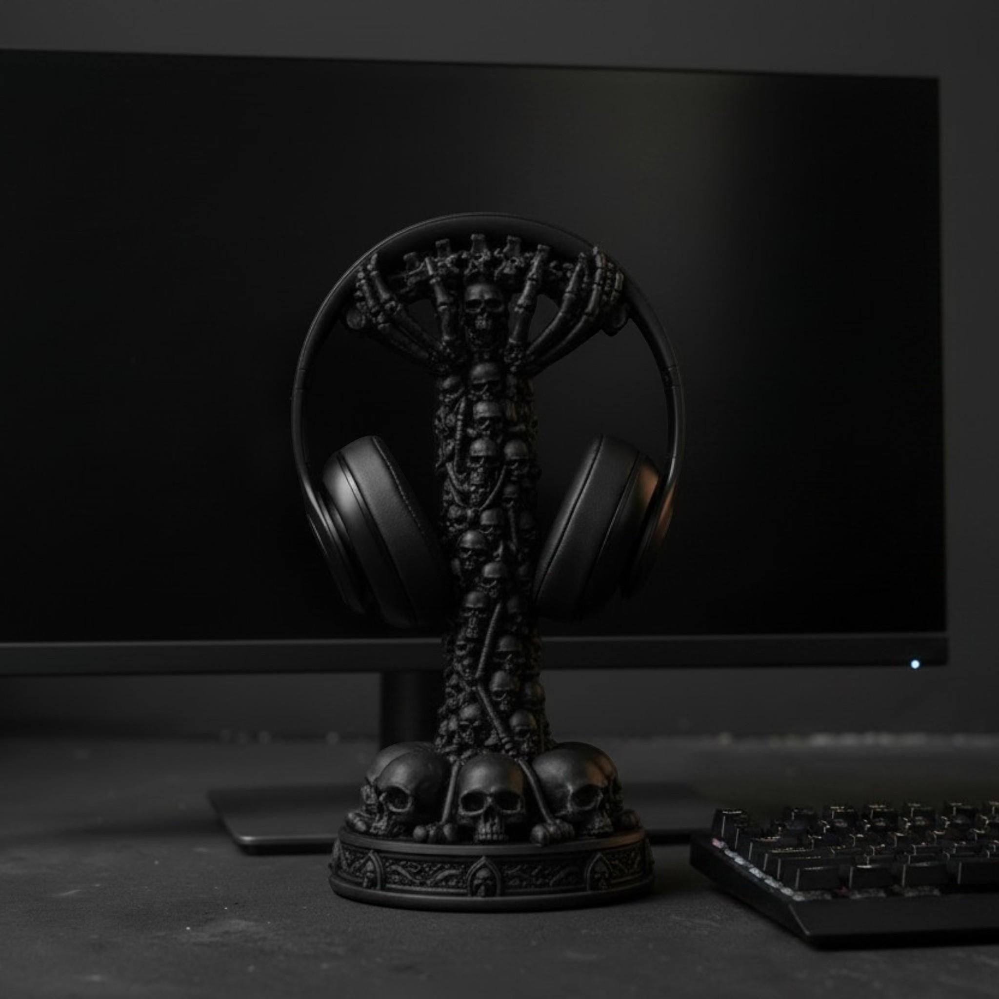 Happy3dWorld matte black skull column headphone stand featuring a stacked skeletal design on a gaming desk setup.